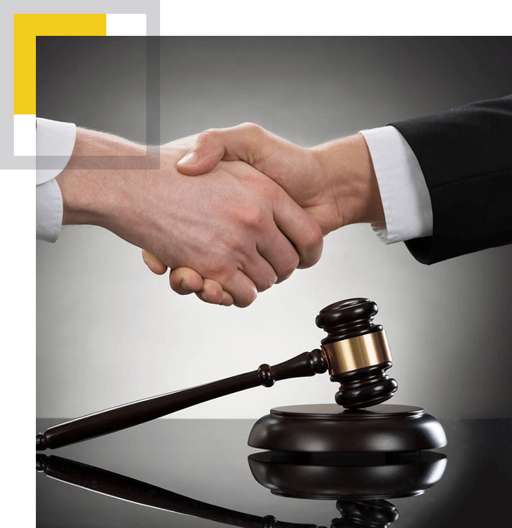 A picture of two people shaking hands over a gavel.